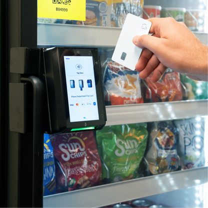 Image showing man swiping a credit card on the POS to open the Genius Vend AI Smart Cooler