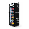 A black smart vending machine with a glass door displaying assorted canned drinks and packaged snacks on shelves. The machine has white text reading 'GRAB & GO' and 'SMART VENDING' on the top panel and side, along with promotional copy about simple tap, easy pick, and auto-paid.